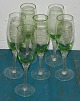 Six champagne glasses with green bowl